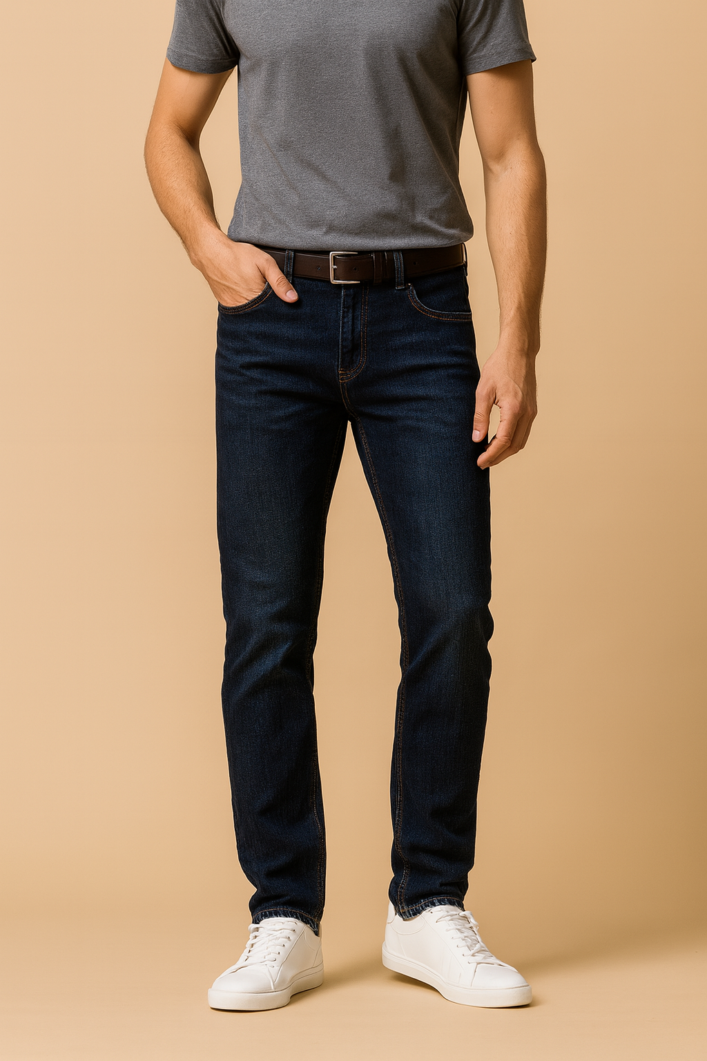 Men’s denim jeans styled casually with grey t-shirt and white sneakers, laid-back modern look.