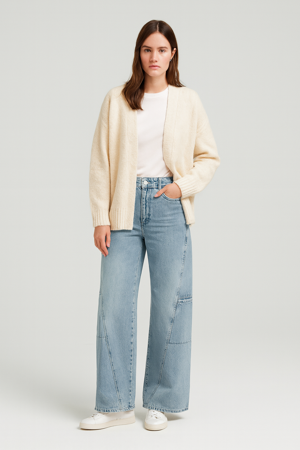 Women’s mid-waist wide-leg jeans in light blue denim, styled with a white t-shirt and cream cardigan for a relaxed classic look.