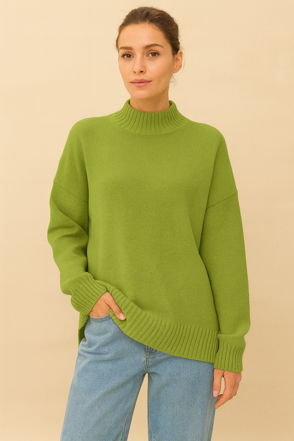 Nordash Oversized Turtleneck Sweater in light green, soft knit texture with shorter ribbed collar, styled with denim trousers in studio lighting.